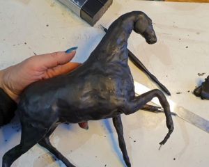 The start of a polymer clay horse sculpture, now in black clay