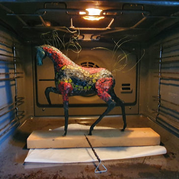 A polymer clay horse sculpture is cured in the oven