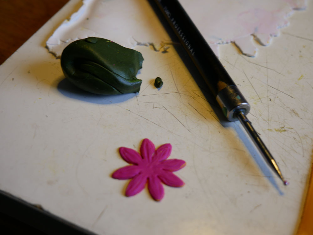 One magenta flower in polymer clay
